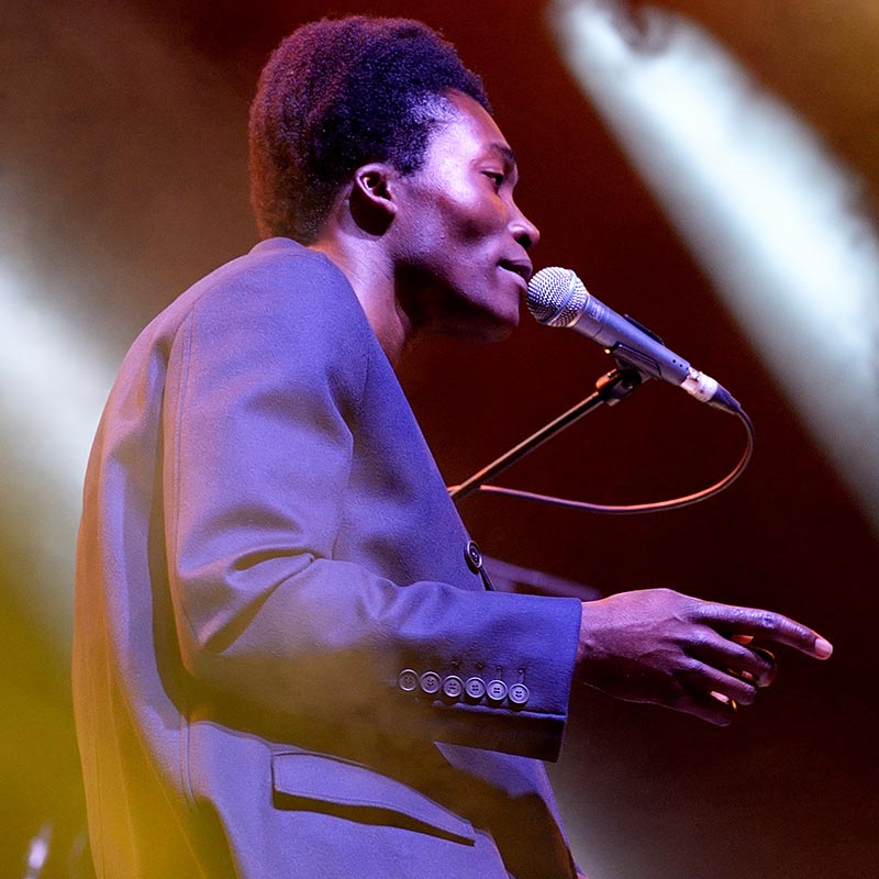 A man in a suit is singing on stage