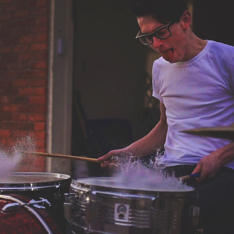 A man playing drums with two sticks.