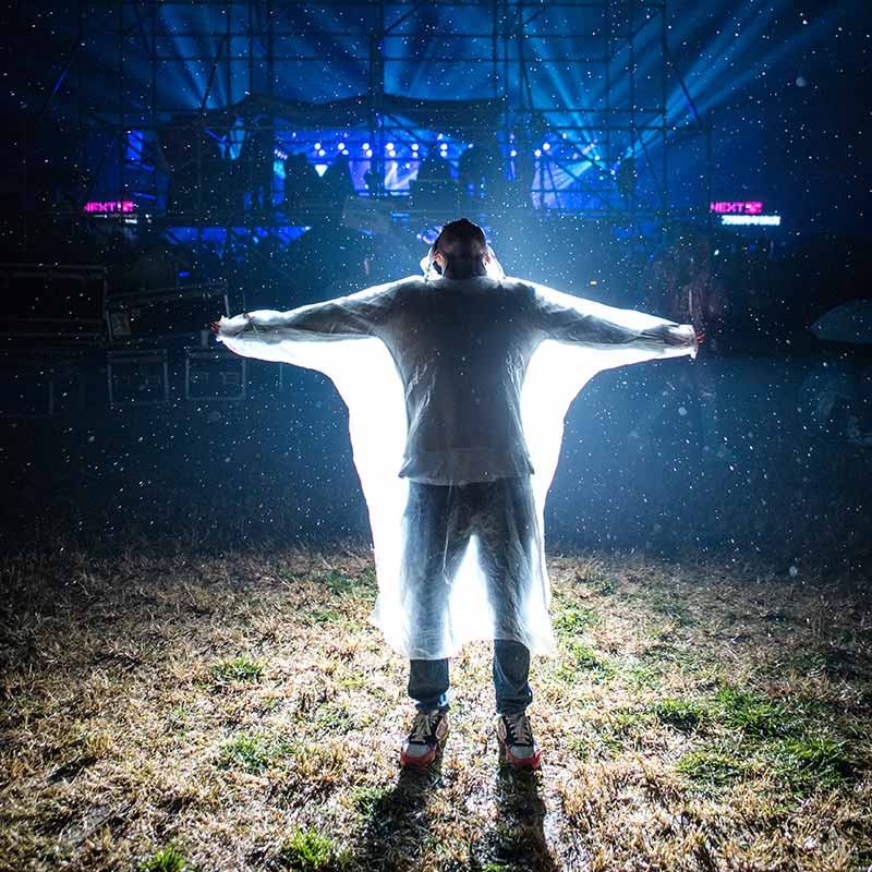 A man standing in the middle of an open field.