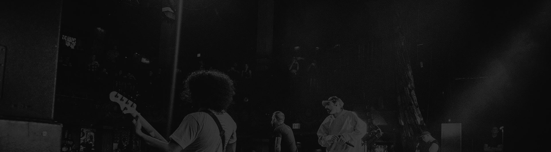 A group of people standing in the dark.
