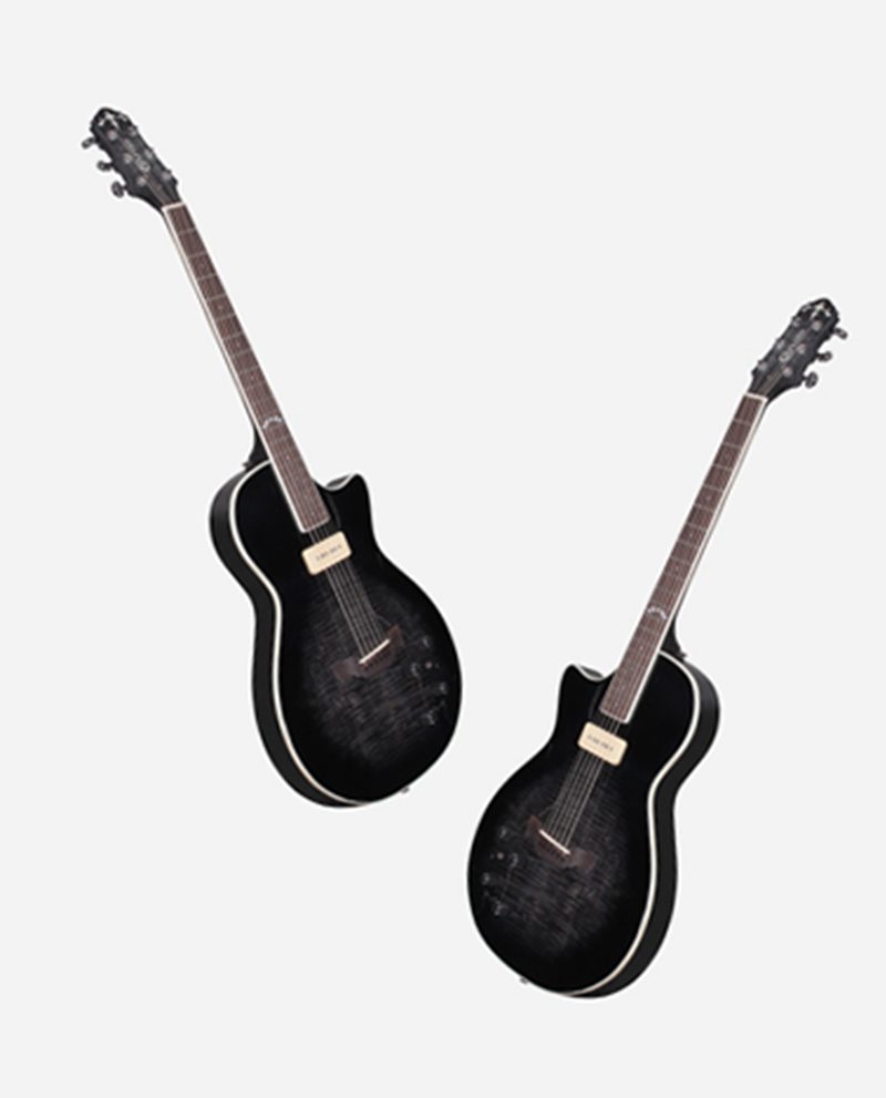 Two black guitars are standing next to each other.