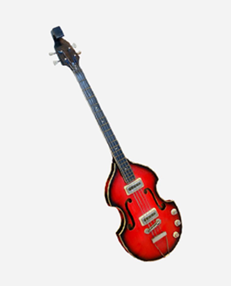 A red guitar is laying down on the floor