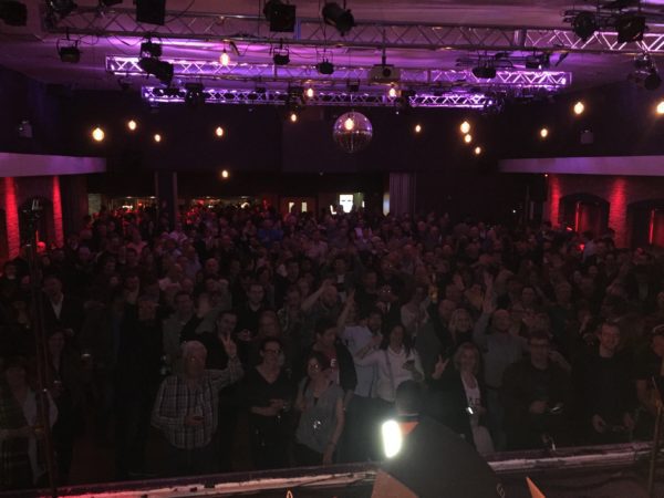 A large crowd of people in front of a stage.