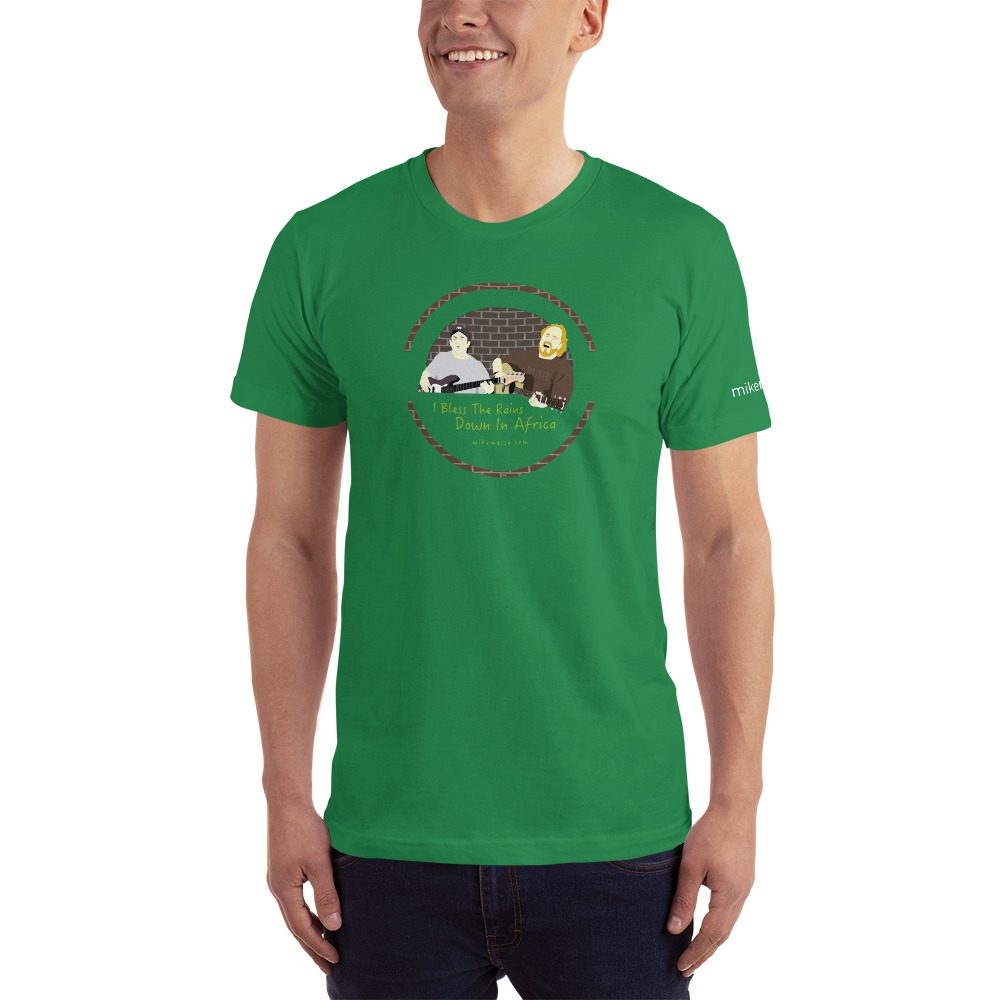 A man wearing a green t-shirt with an image of a person and a dog.
