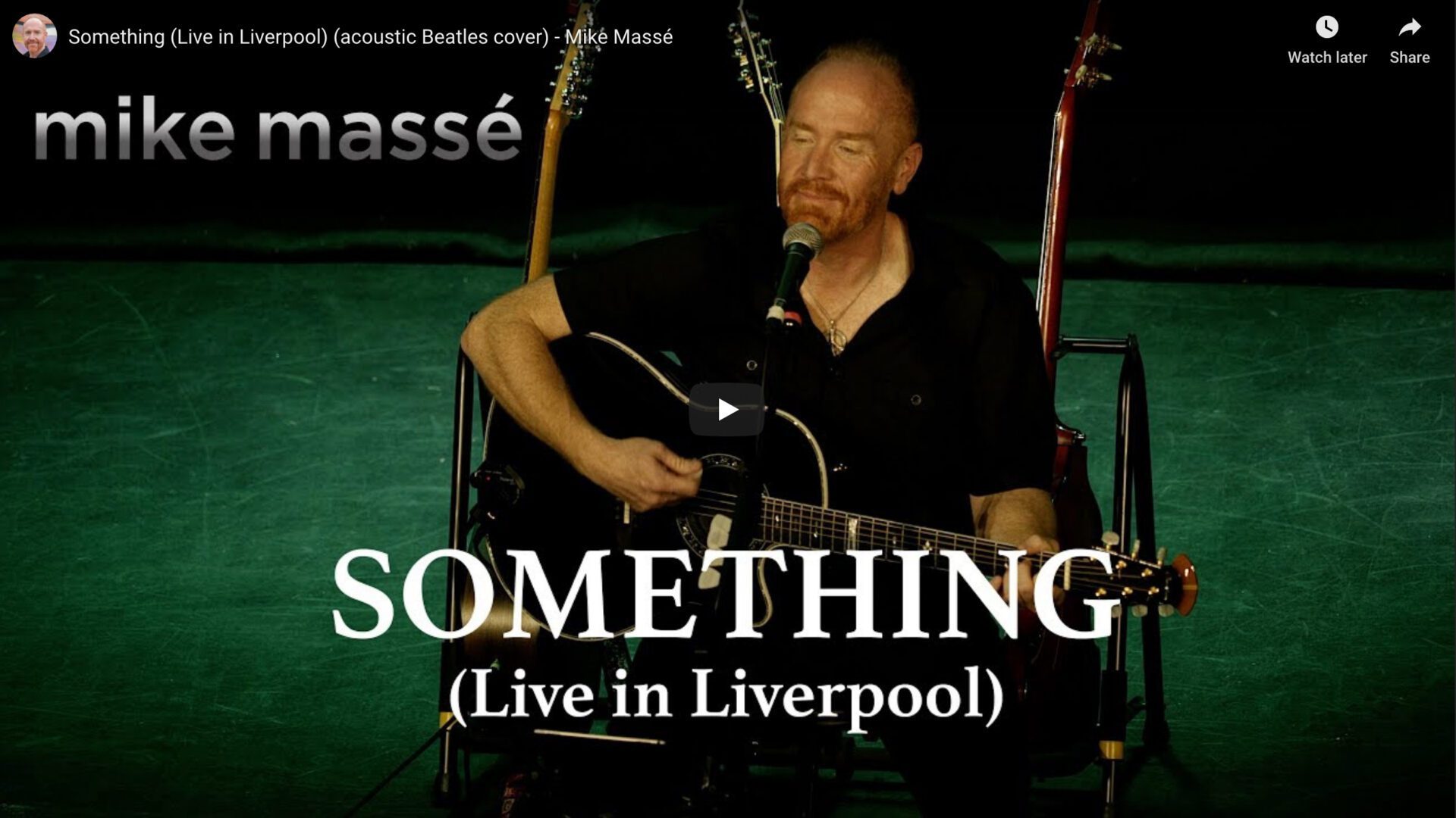A man playing guitar and singing something in the background.