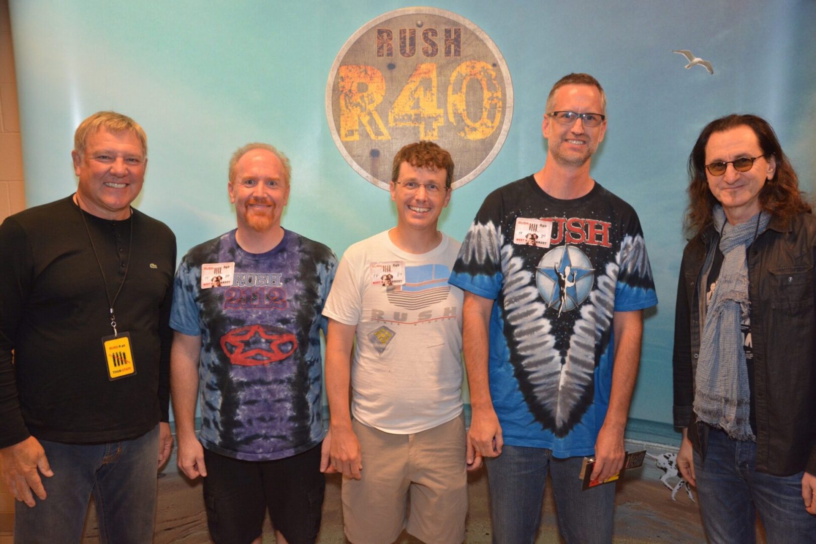 Five people posing at Rush R40 event.